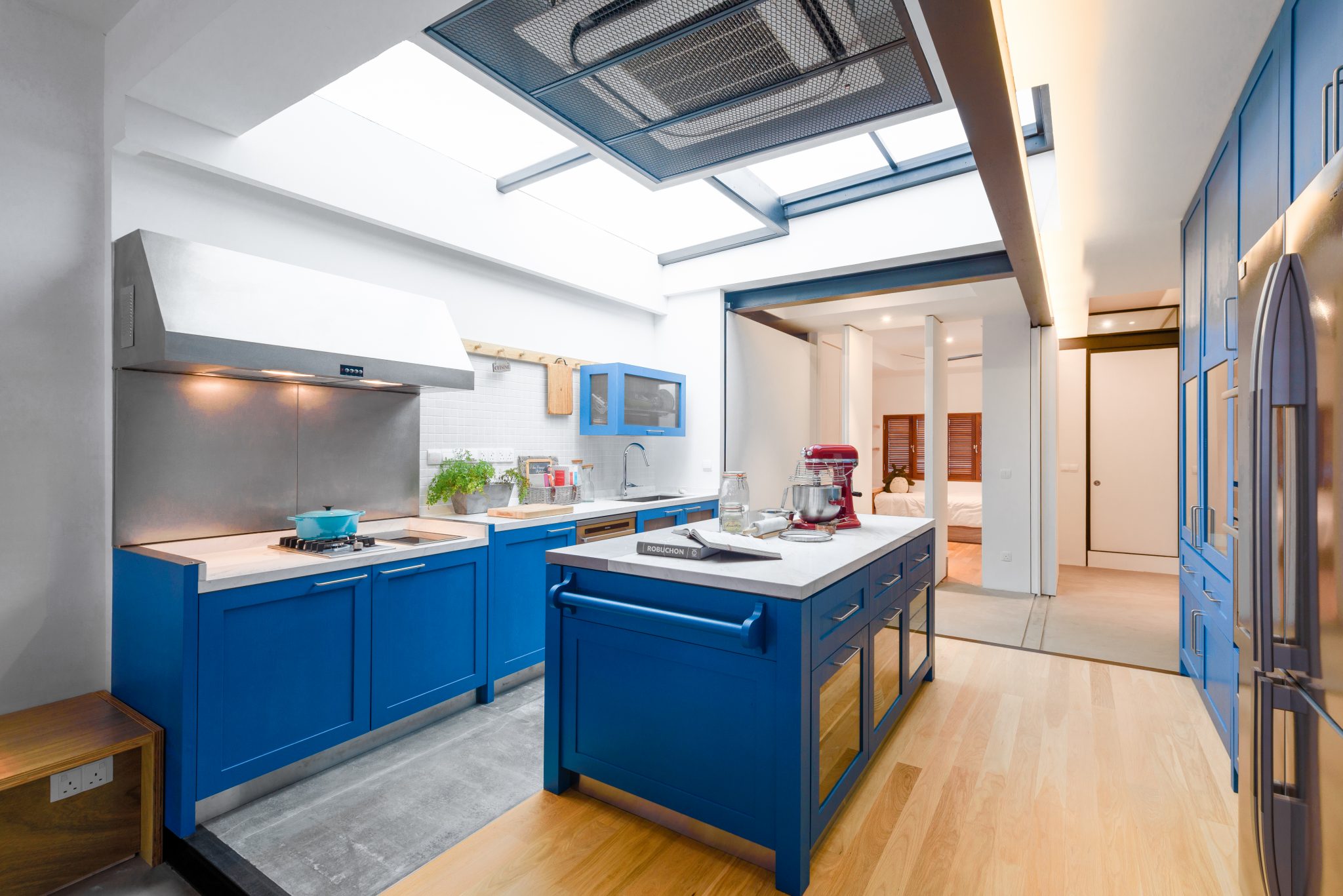 Yong Siak by PIU: bright blue kitchen cabinetry maximising space in a compact apartment